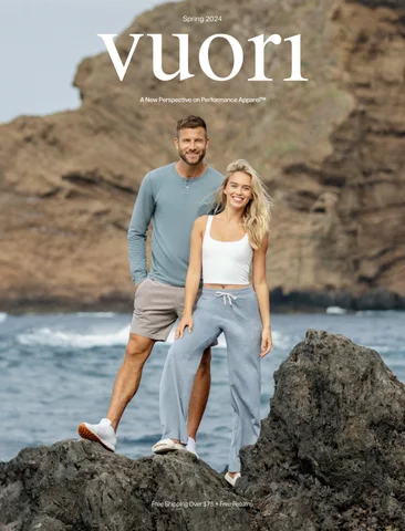 Man and woman wearing Vuori apparel standing on coastal rocks, representing the brand’s calm, performance-lifestyle positioning that contrasts with the fitness industry’s intensity-driven messaging.